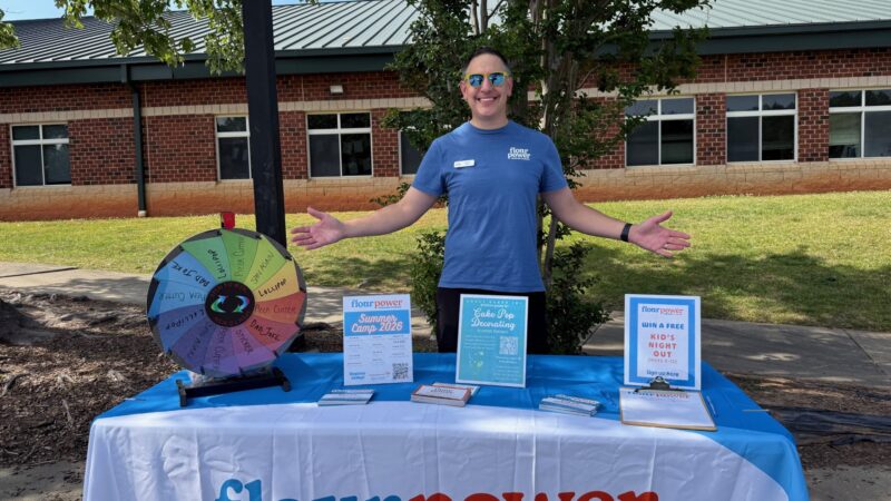 Flour Power Cooking Studios franchise co-owner Andy Siegel at a community booth at HawkRidge Elementary's HawkFest in Charlotte, NC, promoting summer camp 2026
